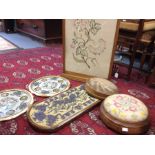 A Victorian mahogany framed firescreen with embroidered floral panel together with two circular foot