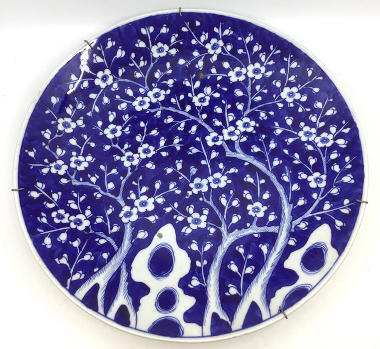 A Chinese blue and white charger decorated with prunus tree, the reverse with central character mark - Image 2 of 2