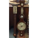 A George III mahogany stick barometer, broken arched pediment above the silvered dial, signed '