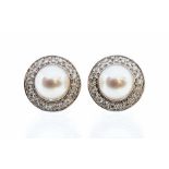 A pair of pearl and diamond 9ct white gold cluster earrings, comprising cultured pearls set to the