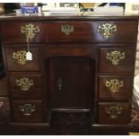 A George II mahogany kneehole desk, circa 1750, fitted with a single drawer to top, a secret