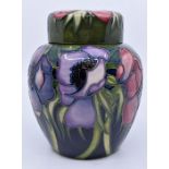 Moorcroft: A Moorcroft 'Anemone' ginger jar on green ground. Height approx 15.5cm. Marks to base.