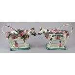 A pair of early nineteenth century pearlware cow creamers, possibly Portobello, c.1820. They are