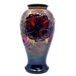 Moorcroft: A Moorcroft 'Hibiscus' pattern vase. Height approx 26cm. Marks to base. Condition: No