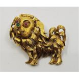 A precious yellow metal, ruby and emerald set "lion" brooch, having engraved fur to face and legs