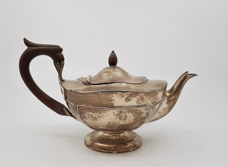 A silver teapot, by Walker & Hall, assayed Sheffield 1910. with wooden finial and loop handle. (