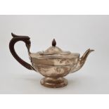 A silver teapot, by Walker & Hall, assayed Sheffield 1910. with wooden finial and loop handle. (