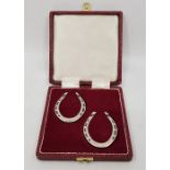 A pair of novelty silver "horseshoe" napkin rings, by Francis Howard Ltd, assayed Sheffield 1976,