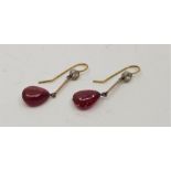 A pair of precious metal, natural Burmese ruby and diamond set drop earrings, each having bezel