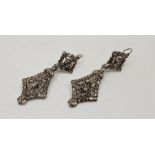 A pair of late 18th/early19th century white metal and diamond drop earrings, each having open work