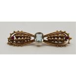 A late 19th century precious yellow metal, aquamarine and ruby 'bow' brooch, set mixed cut