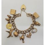 A 9ct. gold charm bracelet, the curb link chain suspending eleven various 9ct. gold charms, with