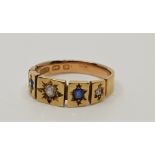 An antique 15ct. gold, diamond and sapphire ring, illusion set three graduated rose cut diamonds and