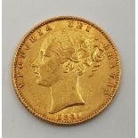 An 1861 Victoria "Young head" gold sovereign, rev. shield.