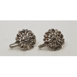 A pair of 19th century white metal and diamond cluster earrings, each with open work circular