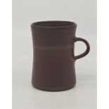 A studio pottery earthenware mug, dark brown glaze, height 10cm.  *purchased as by Lucie Rie by
