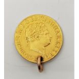 A George III gold sovereign, pierced as a pendant or charm (date indistinct due to piercing).