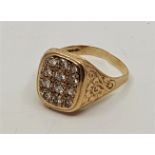 A 9ct. gold gentleman's ring, set twelve round cut clear stones, with floral engraved shoulders,