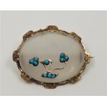 **AWAY**A Victorian milky quartz and cabochon turquoise set oval brooch, within gold plated mount,