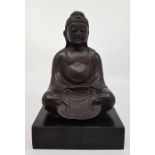 A Chinese bronze Buddha, mounted to later plinth base, total height 21cm.