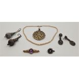 An Edwardian 9ct. gold, amethyst and seed pearl bar brooch, set oval mixed cut amethyst to centre