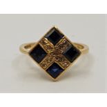 An 18ct. gold, sapphire and diamond ring, having slightly convex lozenge form mount set four