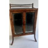 A diminutive 19th century bamboo cabinet