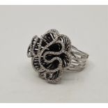 An 18ct. white gold and diamond set dress ring, having large organic form mount supported by wires