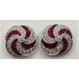 A pair of 18ct. white gold, ruby and diamond earrings, set numerous graduated round cut diamonds and