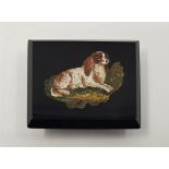 A late 19th/early 20th century micro mosaic brooch, depicting a recumbent spaniel, possibly with