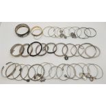 A large collection of silver and white metal bangles, bracelets, brooches and others. (qty)