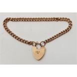 A 9ct. gold curb link chain bracelet, with 9ct. gold heart padlock clasp. (13.7g)