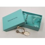 A Tiffany & Co. silver key ring and fob, stamped "T & Co" makers mark and assay marks for London