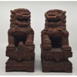 A pair of Chinese Qing dynasty laquered Fo dogs. (2)