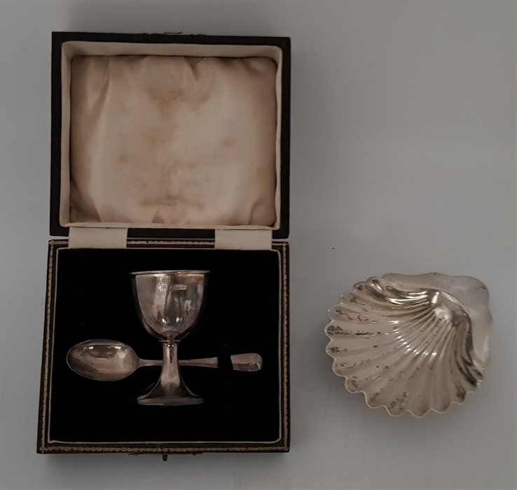 A silver egg cup and spoon christening set, by Barker Brothers Silver Ltd, Birmingham 1936-37, (left