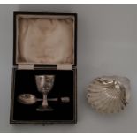 A silver egg cup and spoon christening set, by Barker Brothers Silver Ltd, Birmingham 1936-37, (left