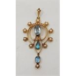 A 15ct. gold, aquamarine and seed pearl set pendant, the open work mount set mixed cut aquamarine to