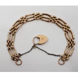 A 9ct. gold gate bracelet, with 9ct. gold heart padlock clasp. (10.9g) Condition: Solder repairs (as