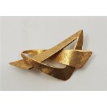 An 18ct. textured 'tied bow' brooch, length 57mm. (gross weight 7.6g)