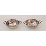 A pair of ornate Hanau silver small twin handled bowls, Hanau psuedo marks for Simon Rosenau (Bad