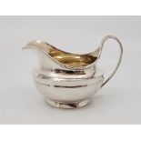 A George III silver cream jug, by Robert Garrard II, assayed London 1819. (131.1g)