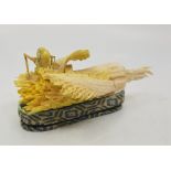A Japanese Taisho period ivory okimono, carved and stained as a grasshopper feeding on a white