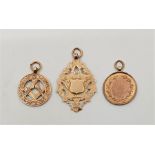 An Edwardian 9ct. rose gold engraved and pierced Masonic fob, together with a circular wreath design