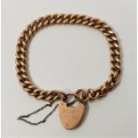 A 9ct. gold curb link chain bracelet, with 9ct. gold heart padlock clasp. (27.4g)