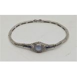 A precious white metal, sapphire and diamond bracelet, the navette form mount with pierced gallery