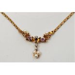 A 9ct. gold, diamond, ruby and seed pearl pendant necklace, set single cut diamonds, rubies and seed