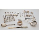 A small collection of silver table ware, to include: a six division silver toast rack, by