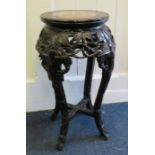 A Chinese carved hardwood and marble inset jardinière stand with shaped supports. 28cm diameter