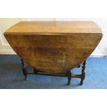A 1920's oak oval 17th century style gate leg table with barley twist frame. 107cm Provenance: