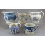 A group of mostly early nineteenth century sprig moulded jugs and a mug, c. 1810-30. To include a